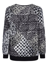 Schwarz-weiß gemusterter Pullover mit gewebtem Design, wahrscheinlich aus Baumwolle oder Polyester.