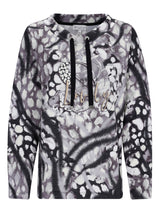 Schwarz-weißer Blumenmuster-Langarm-Top mit Reißverschluss-Detail.