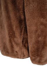 A plush chocolate-brown teddy jacke with soft faux fur and visible side seam for cozy winter wear