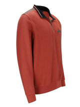 Orange gemusterter Polo-Shirt mit schwarzen Akzenten und Kragen, wahrscheinlich aus Baumwolle oder Polyester-Mischung gefertigt.