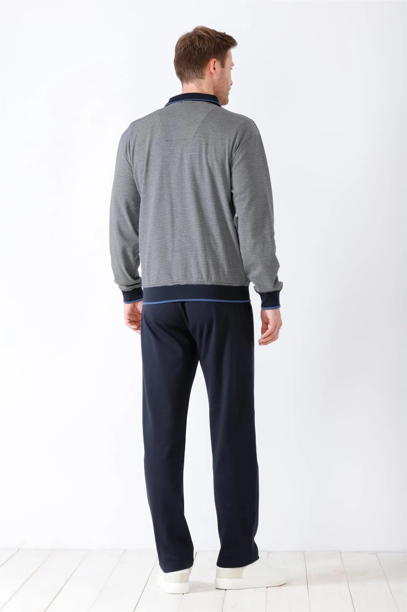 Gestreiftes Langarm-Poloshirt für Herren mit marineblauem Kragen, Manschetten und Saum, gepaart mit einer einfarbigen marineblauen Jogginghose.