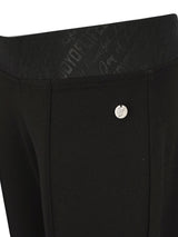 Schwarze maßgeschneiderte Anzughosen mit silberner Knopf- und Reißverschlussdetails.