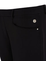 Schwarze maßgeschneiderte Hosen mit silbernen Knöpfen und Reißverschluss, wahrscheinlich von einer Designer-Marke.