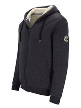 Moncler schwarze Kapuzenjacke mit Lammfellfutter.