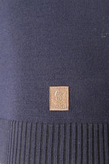 Marineblauer Strickstoff mit einem kleinen kupferfarbenen quadratischen Logoaufnäher.