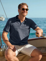 Marineblaues Poloshirt mit diagonalem Jacquardmuster, weißem Kragen- und Ärmelbesatz