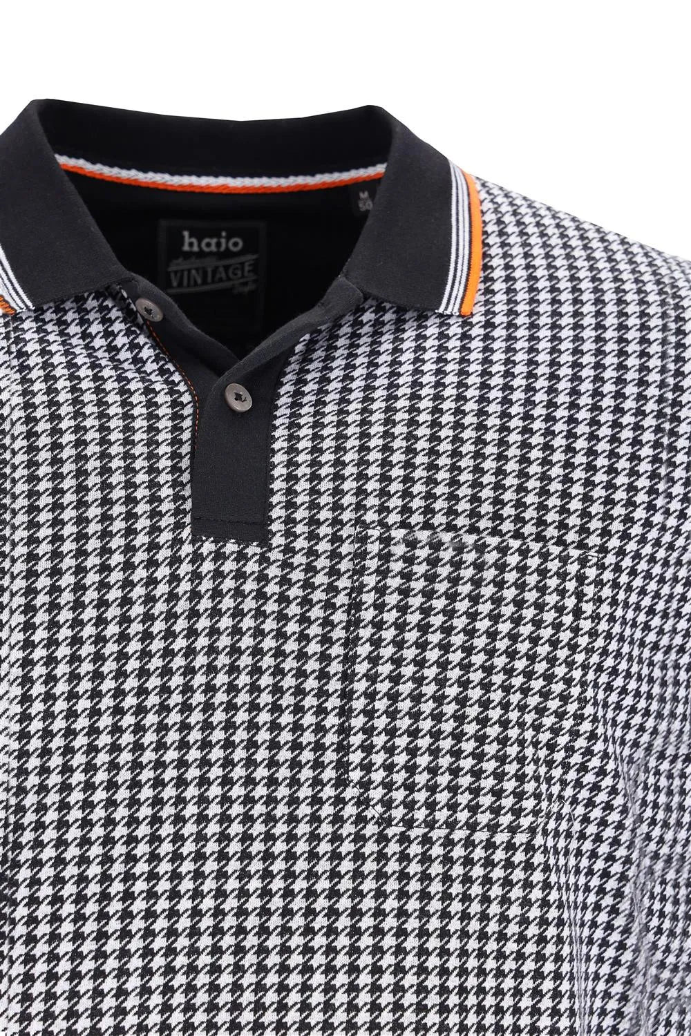 Poloshirt mit Hahnentrittmuster und orange-schwarzen Akzenten, aus Baumwolle.