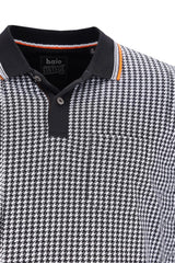 Poloshirt mit Hahnentrittmuster und orange-schwarzen Akzenten, aus Baumwolle.