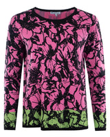 Rosa und grüner Pullover mit Blumendruck und schwarzen Akzenten.