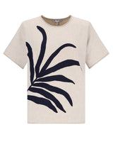 Cremefarbenes T-Shirt mit großem, marineblauem Palmenblattmuster, Freizeitkleidung.
