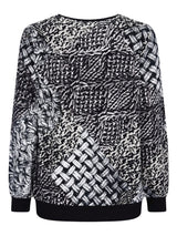 Schwarz-weiß gemusterter Pullover mit gewebtem Design, wahrscheinlich aus Baumwolle oder Polyester.