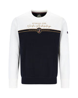 Marineblauer und weißer Pullover mit Rundhalsausschnitt und goldenem Emblem.